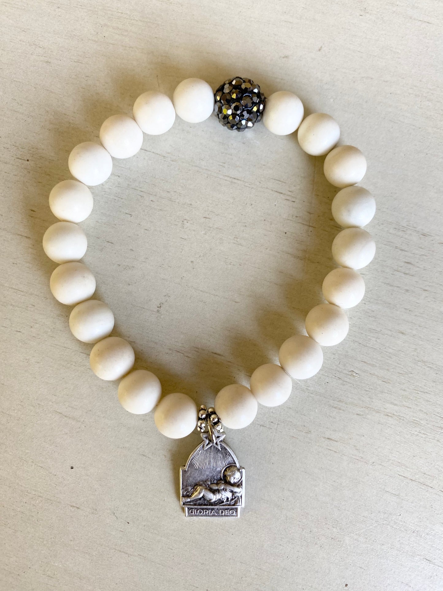 Infant Jesus Medal with white beads and silver accents stretch bracelet
